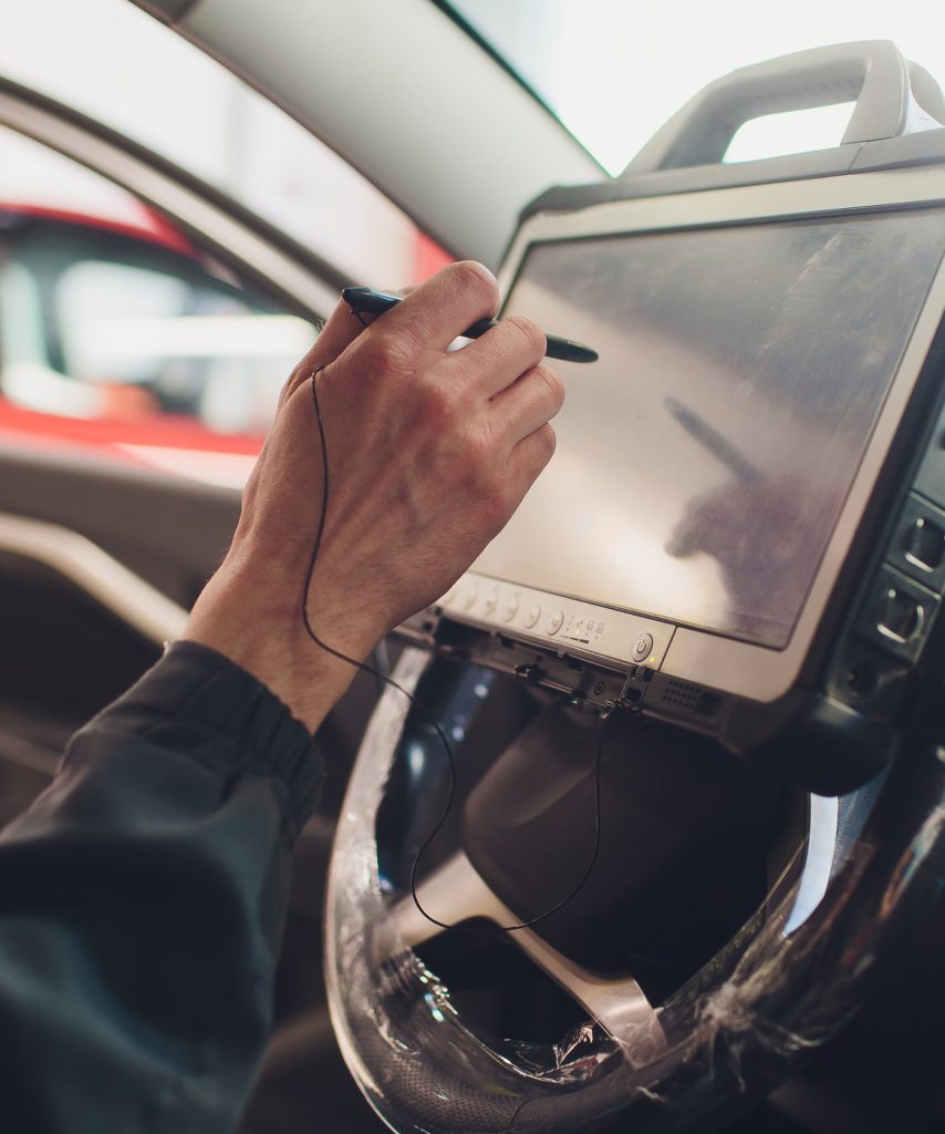 Mechanic diagnosing a vehicle using a computer system - Car Diagnostics York