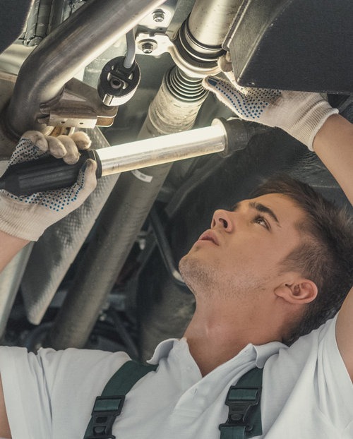 Mechanic looking under a vehicle - MOT Testing York